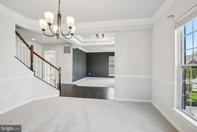 a large kitchen with stainless steel appliances granite countertop a refrigerator and a stove top oven