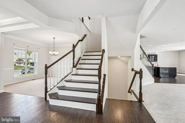 a bathroom with a granite countertop bathtub shower sink vanity mirror and toilet