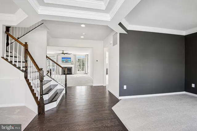 a view of an empty room with a fireplace and a window