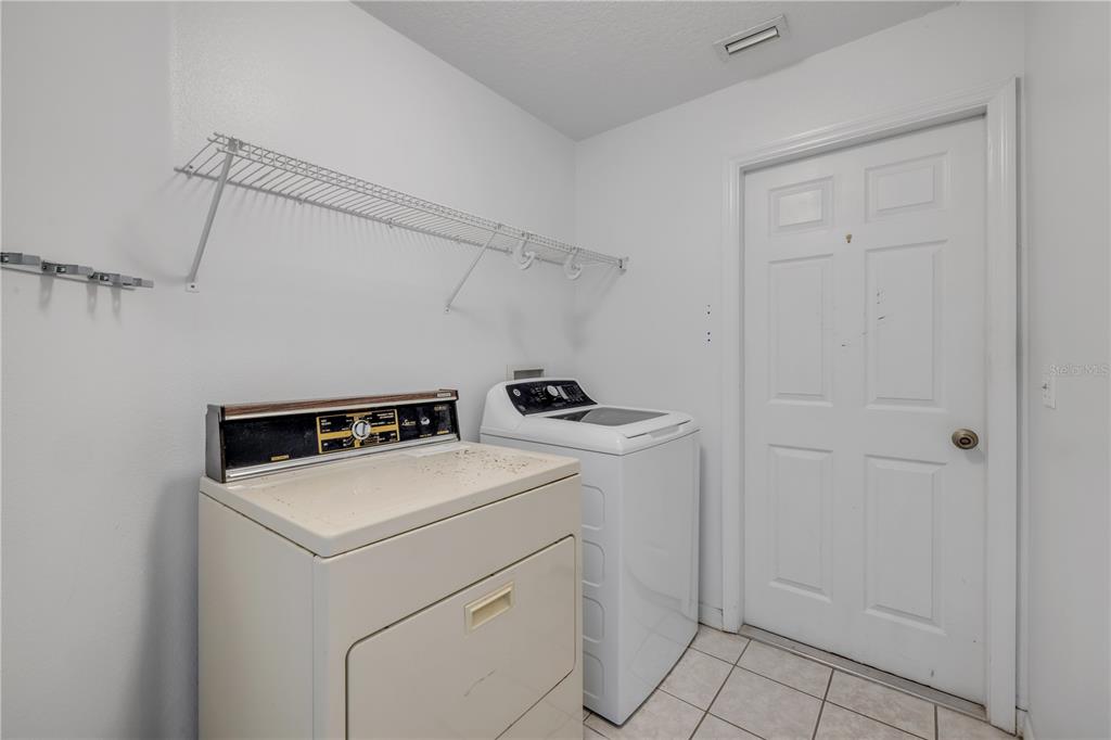 192 Azalea Road Edgewater, FL 32141 - Photo 26 of 94 a utility room with dryer and washer