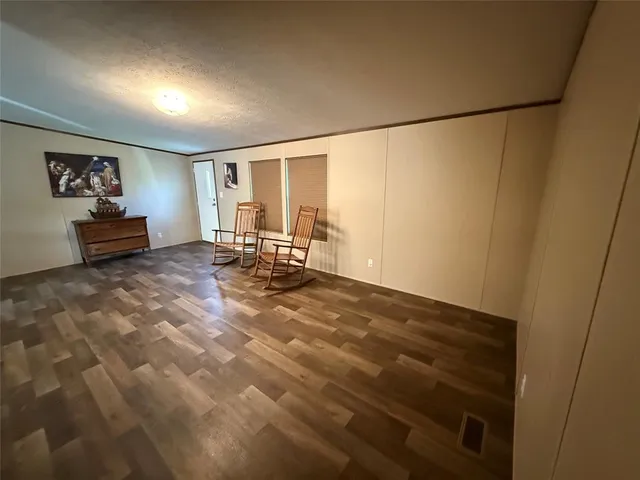 a view of a livingroom with furniture and a window