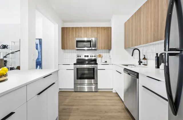 a kitchen with stainless steel appliances a stove sink and cabinets