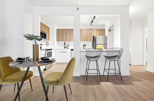 a view of a dining room with furniture and a potted plant