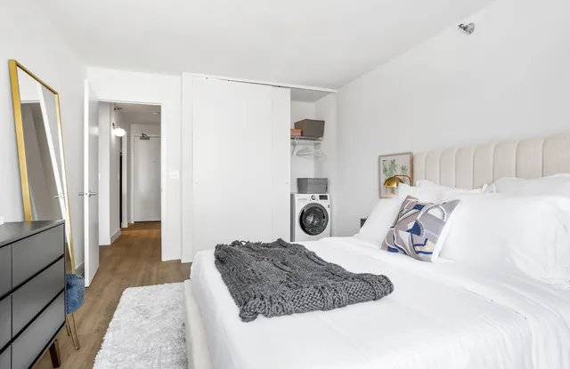 a bedroom with a large bed and a couch