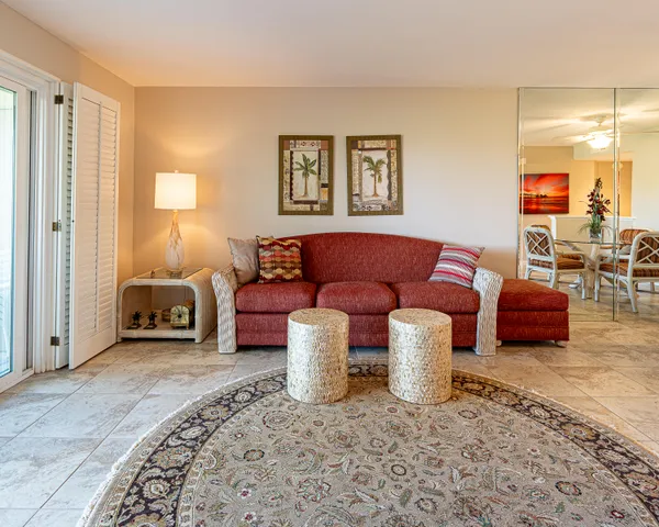 a living room with furniture and a lamp