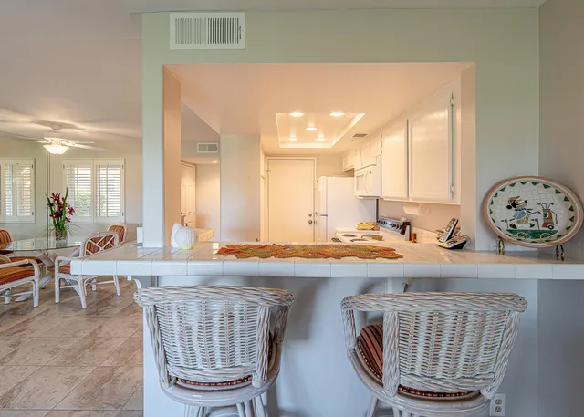 a living room with a table and chairs