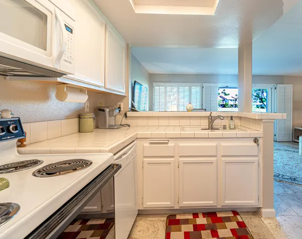 a kitchen with a stove a sink and a refrigerator