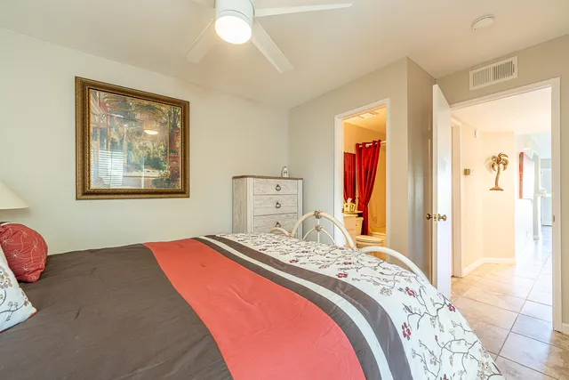 a bedroom with a bed and a painting on the wall