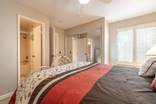 a bedroom with a bed and a mirror