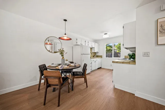 a view of a dining room with furniture window and wooden floor