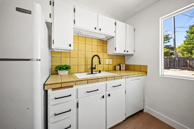 a kitchen with stainless steel appliances a sink stove and cabinets