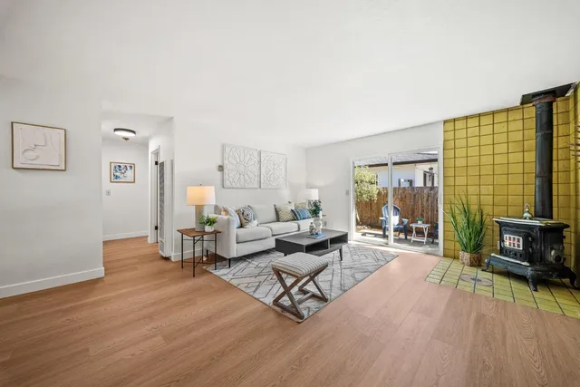 a living room with furniture and a flat screen tv with wooden floor