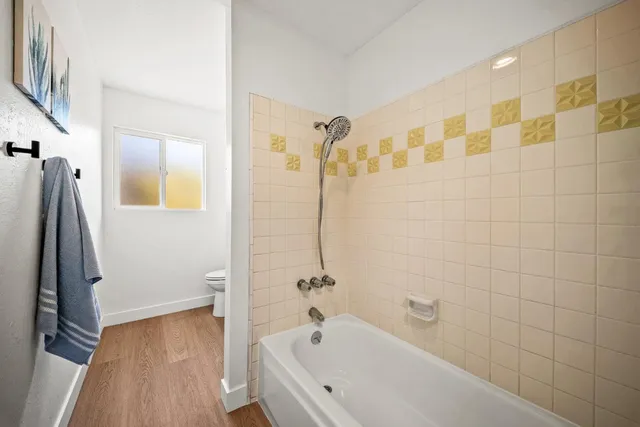 a bathroom with a bathtub and a shower