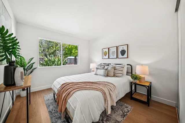a bedroom with a bed and a potted plant