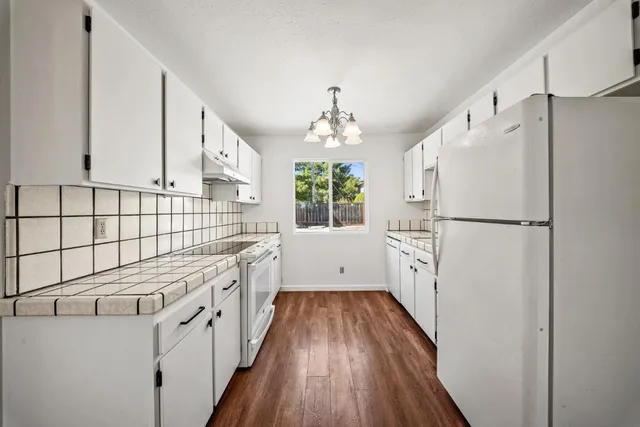 a kitchen with stainless steel appliances a refrigerator and a stove