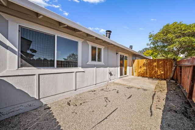 a view of a house with wooden fence