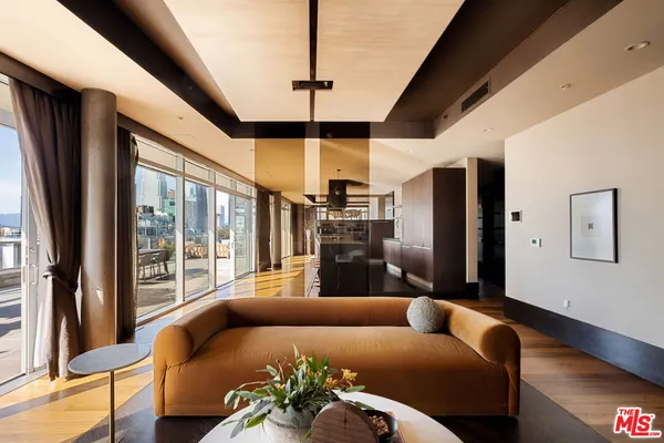 a living room with furniture stove and large window