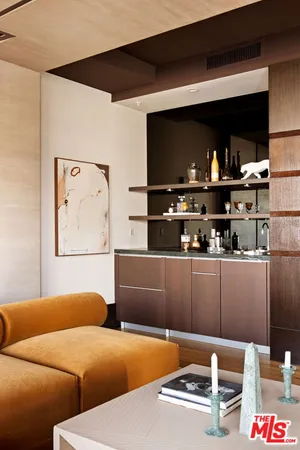 a room with a couch and a bookshelf