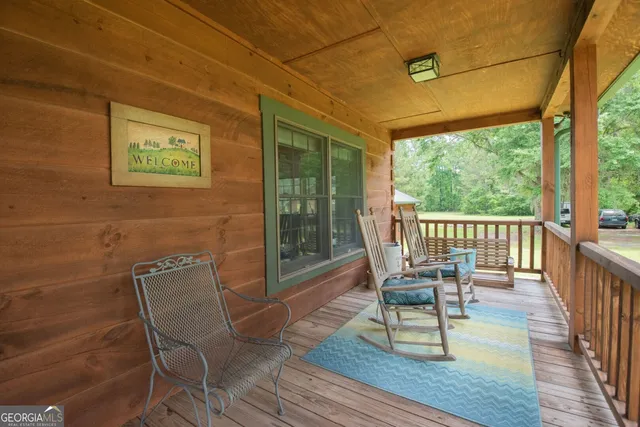 a living room with furniture a fireplace and a dining table with wooden floor