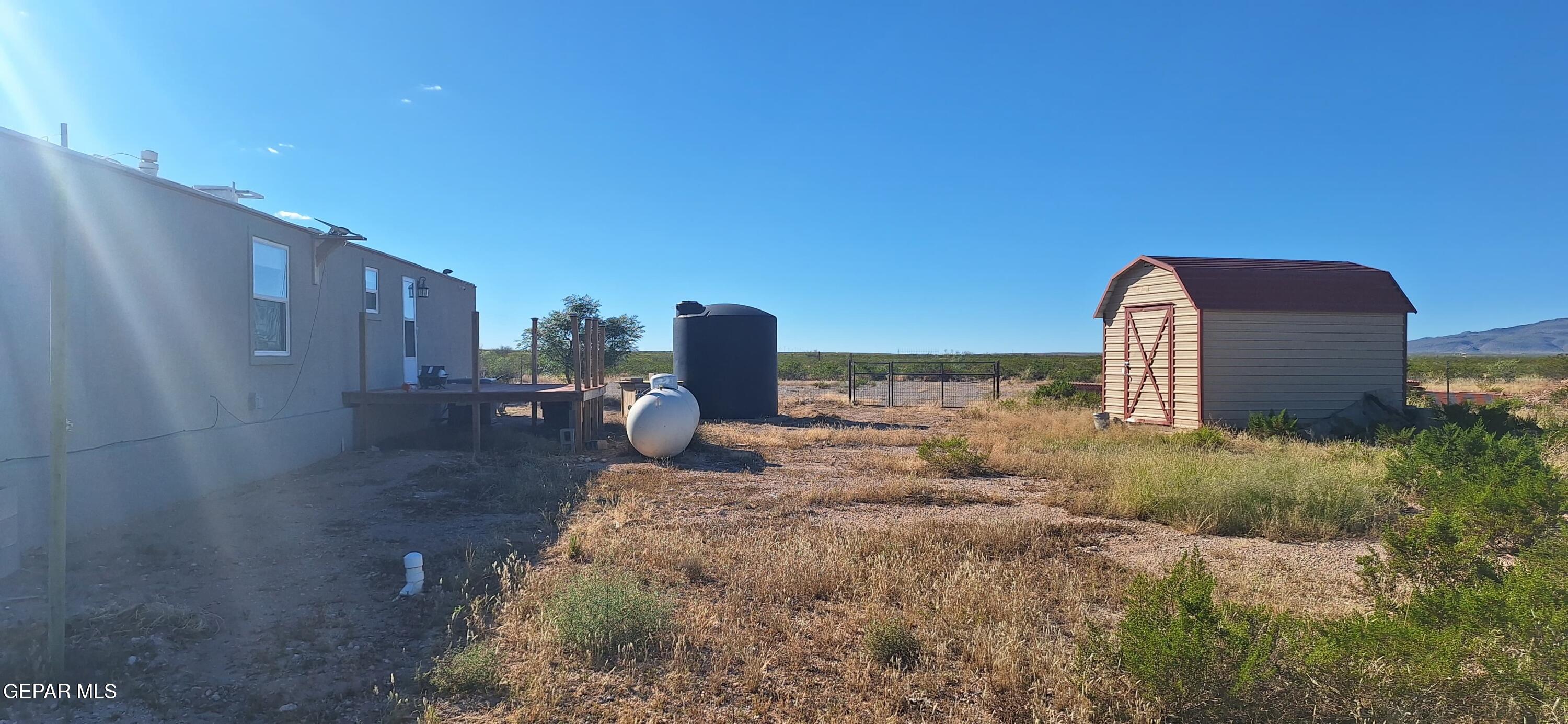 100 North Sparks Ranch Road Dell City, TX 79847 - Photo 3 of 19 a backyard of a house with lots of green space