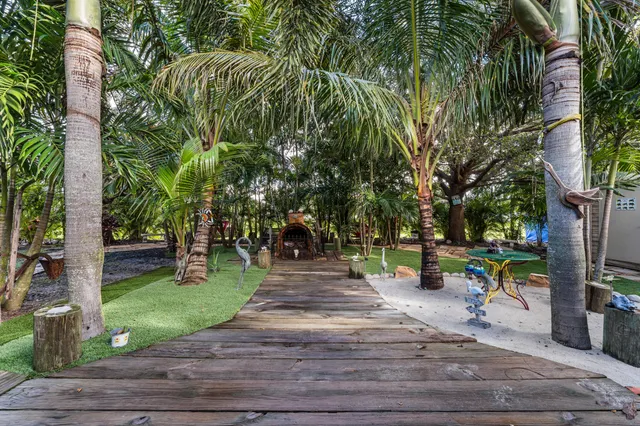 a park with large trees and a pathway