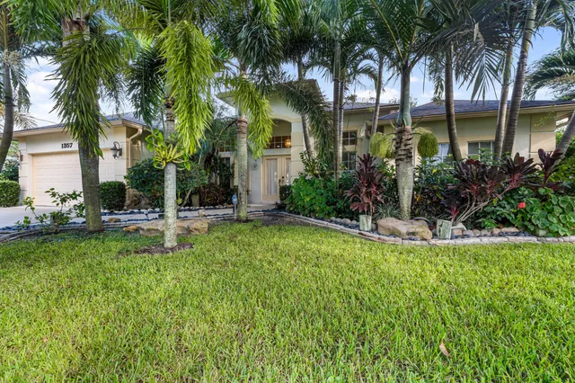 a view of a house with a swimming pool and sitting area