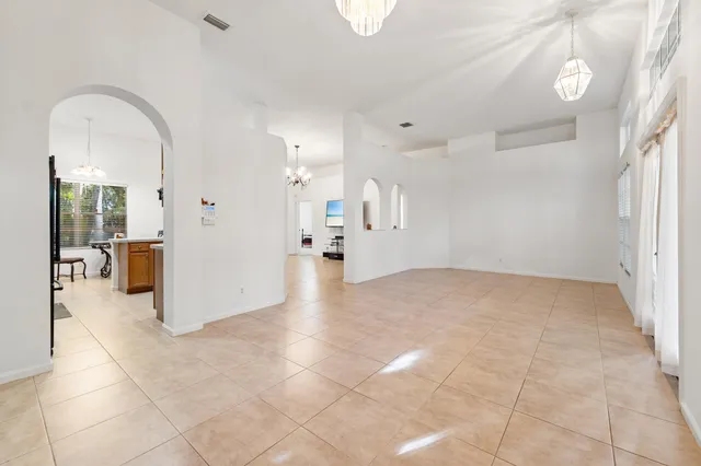 a view of a hallway with bathroom and a shower