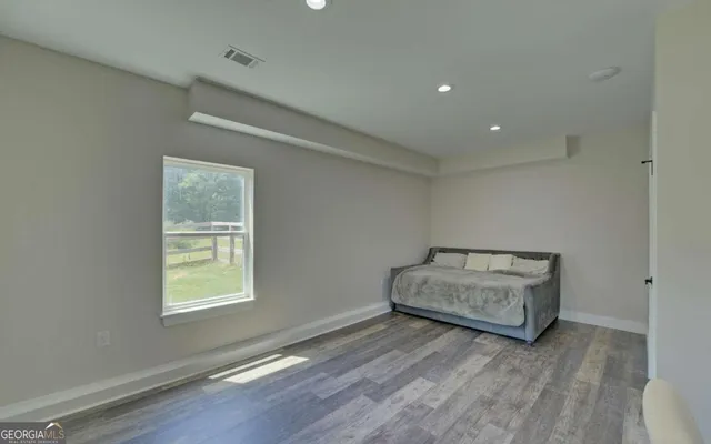 a view of a hallway with a chandelier fan and wooden floor