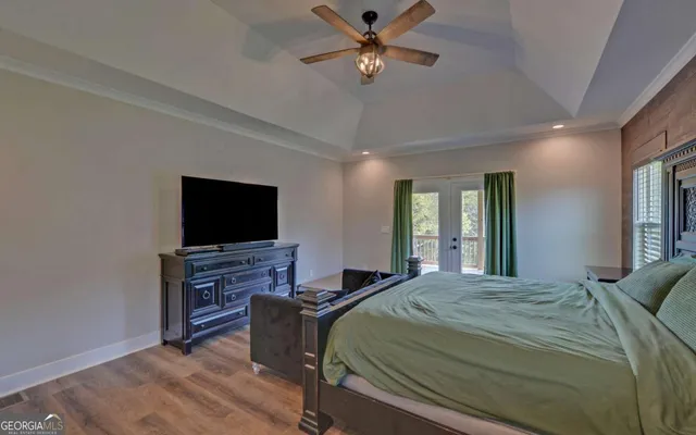 a bedroom with a bed and a flat screen tv