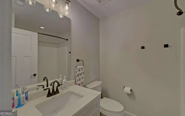 a bathroom with a double vanity sink mirror and shower