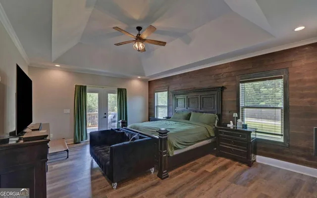 a bedroom with a bed and wooden floor