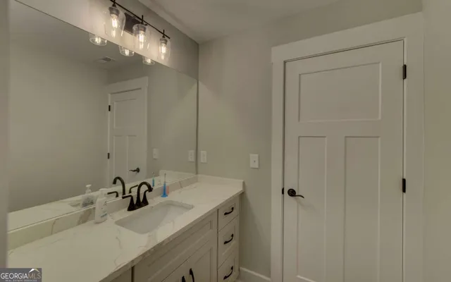 a view of walk in closet with clothes