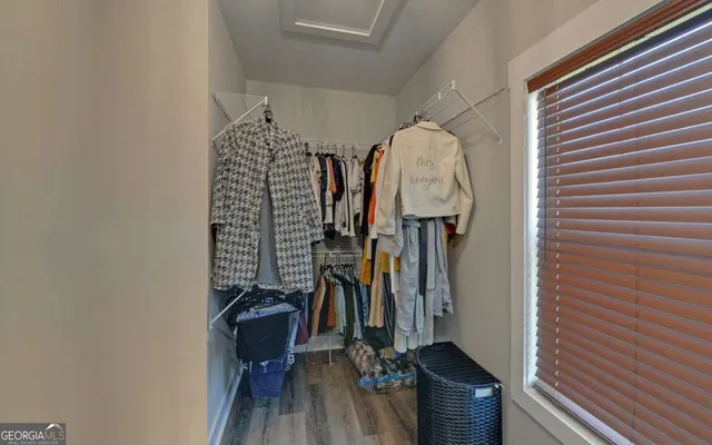 a view of a balcony with floor to ceiling windows with wooden floor