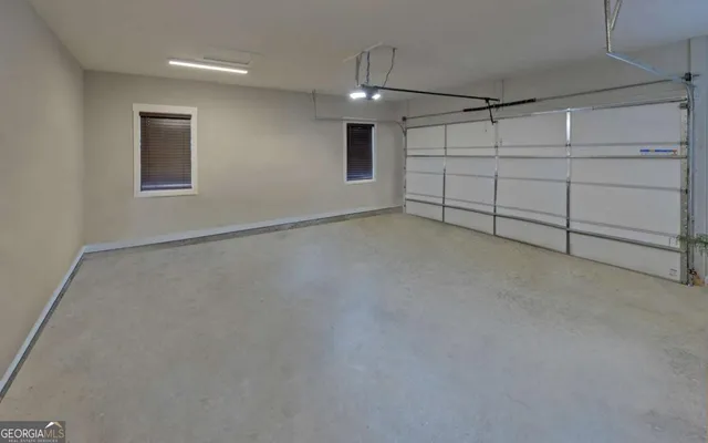 an aerial view of a house with a yard and large trees