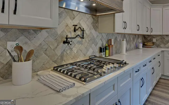 a kitchen with a stove and cabinets