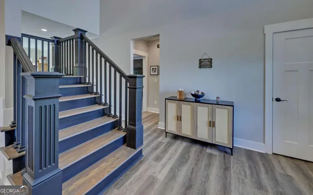 a view of a hallway with entryway wooden floor and front door
