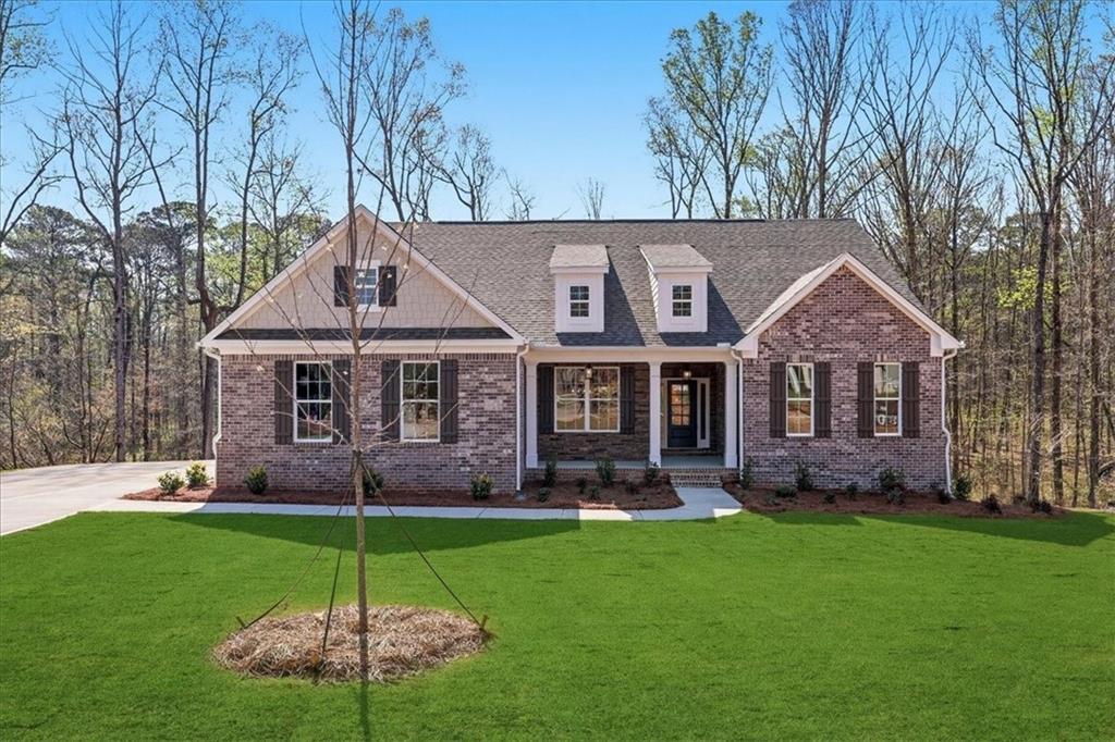 2013 Seclusion Trail Monroe, GA 30656 - Photo 2 of 63 a front view of a house with garden