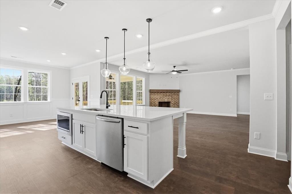 2013 Seclusion Trail Monroe, GA 30656 - Photo 22 of 63 a large kitchen with kitchen island a sink stainless steel appliances and cabinets