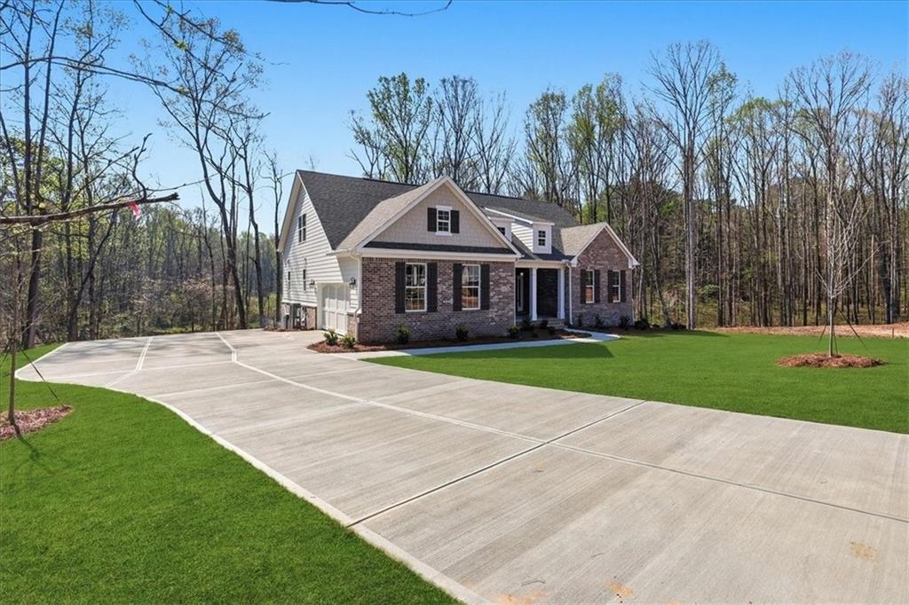 2013 Seclusion Trail Monroe, GA 30656 - Photo 3 of 63 a front view of a house with a yard