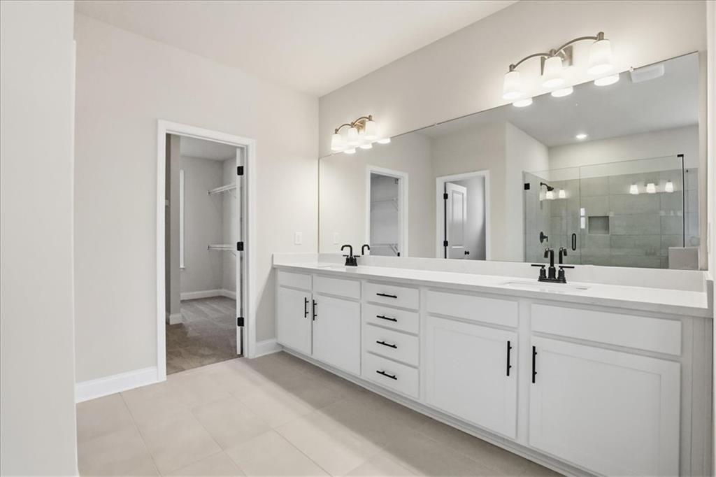 2013 Seclusion Trail Monroe, GA 30656 - Photo 38 of 63 a spacious bathroom with a granite countertop sink mirror and double
