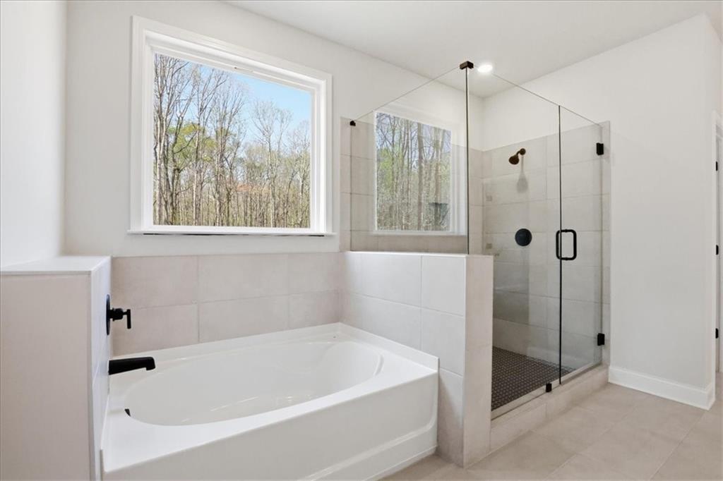 2013 Seclusion Trail Monroe, GA 30656 - Photo 39 of 63 a white bath tub sitting next to a shower