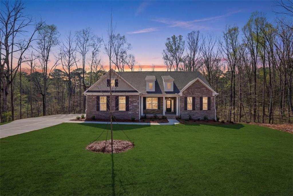 2013 Seclusion Trail Monroe, GA 30656 - Photo 5 of 63 a front view of a house with a garden