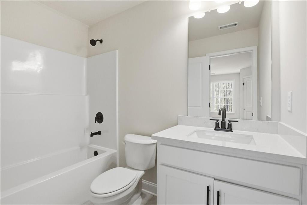 2013 Seclusion Trail Monroe, GA 30656 - Photo 56 of 63 a bathroom with a sink a toilet and shower