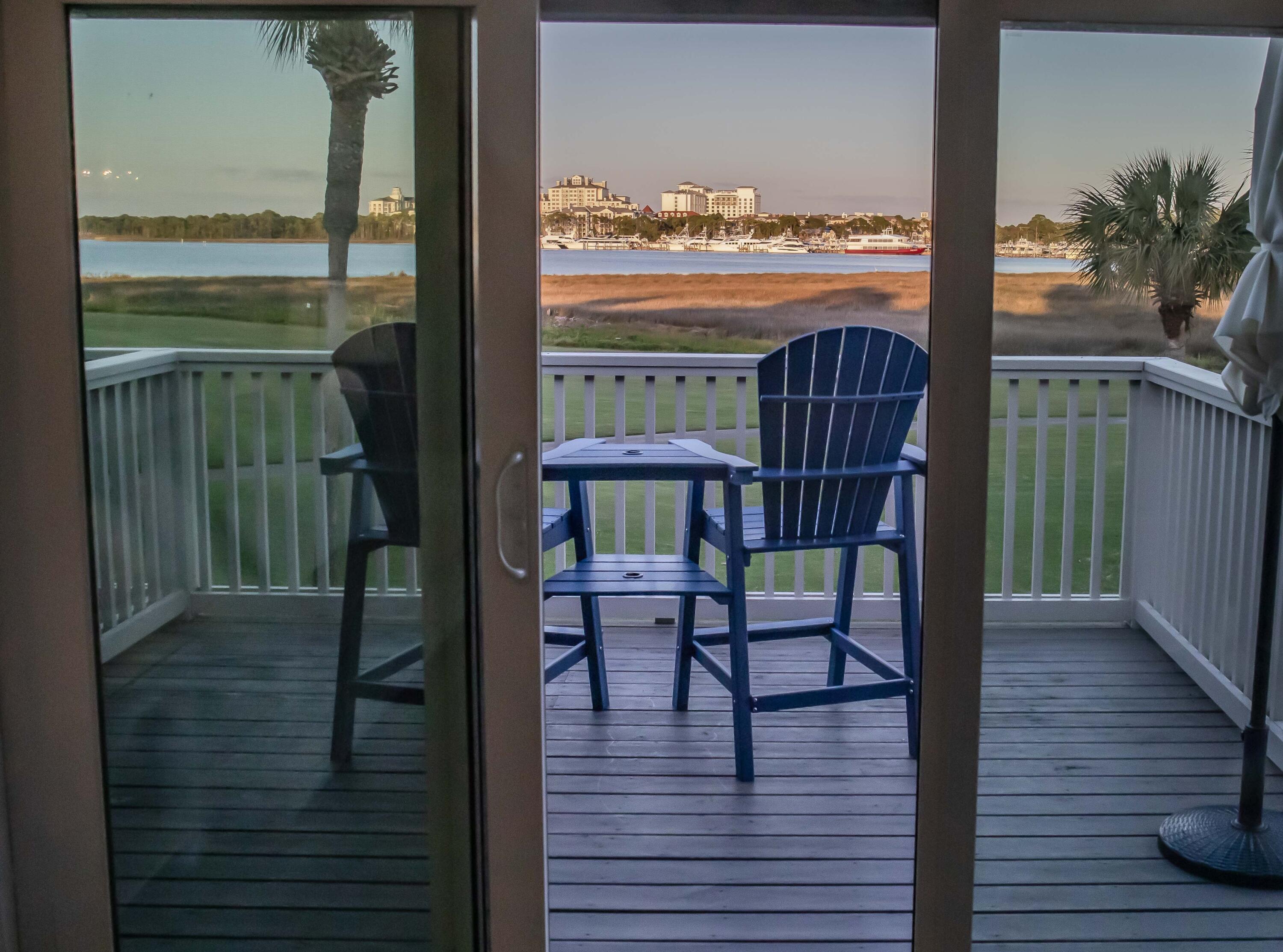 822 Harbour Point Drive, Unit 822 Miramar Beach, FL 32550 - Photo 2 of 41 a view of a balcony with chairs and wooden floor