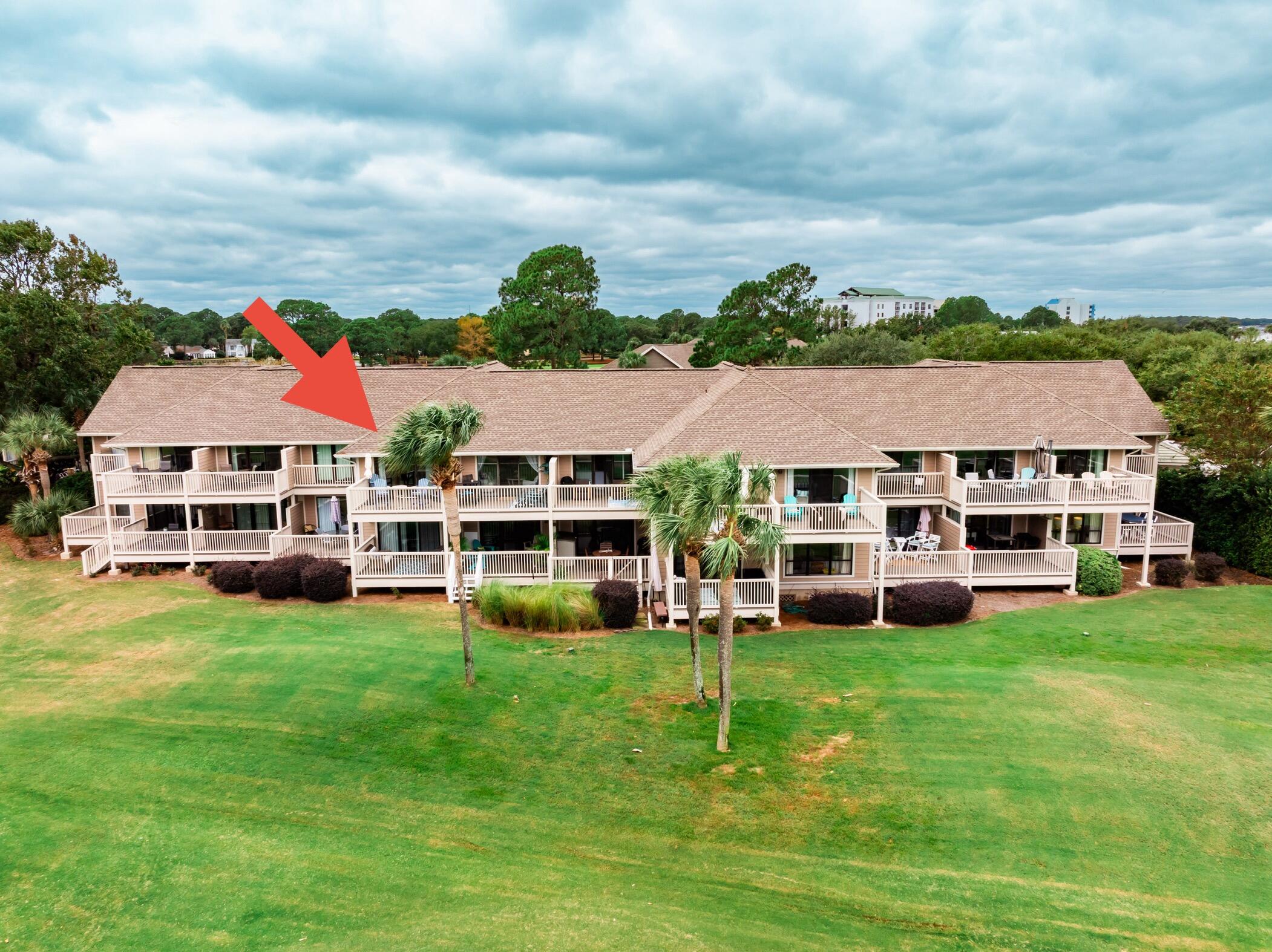 822 Harbour Point Drive, Unit 822 Miramar Beach, FL 32550 - Photo 33 of 41 a view of a big yard with table and chairs under an umbrella