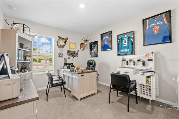 a bedroom with a bed and a flat tv screen on dresser