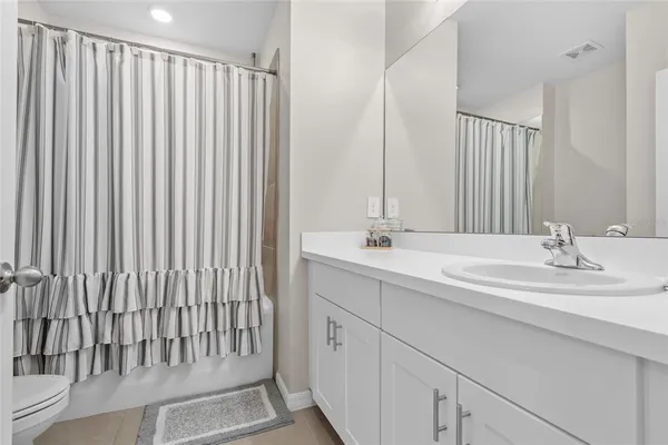 a balcony with couple of chairs and a couch