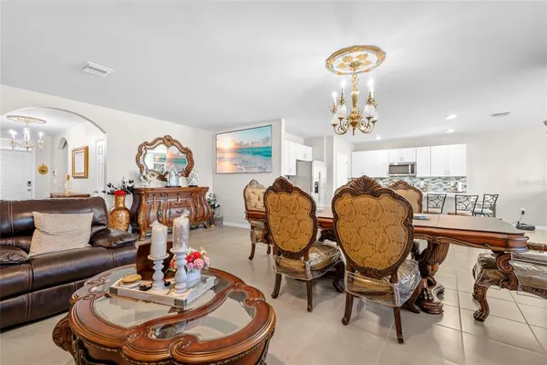 a living room with furniture and a chandelier