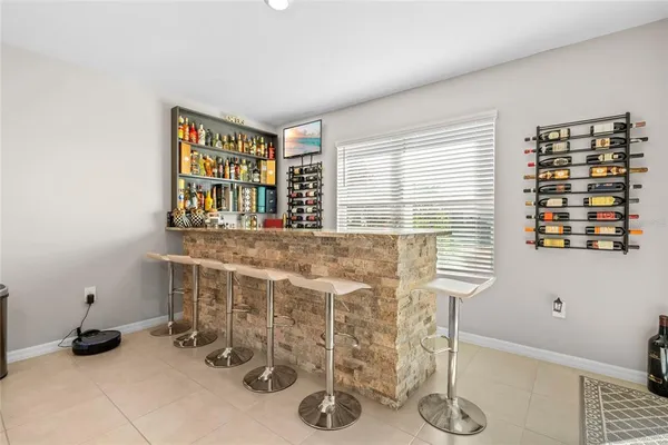 a kitchen with stainless steel appliances kitchen island granite countertop a stove a sink a dining table and chairs