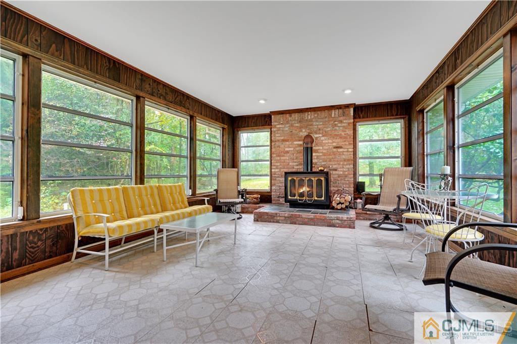 3 Delwood Road Chester, NJ 07930 - Photo 11 of 25 a living room with furniture and floor to ceiling windows